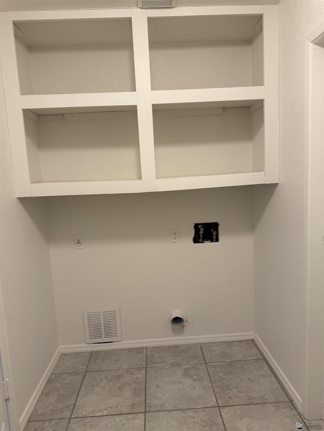 1435 S Thomas Ave, Yuma, AZ 85364 - clothes washing area with hookup for an electric dryer, baseboards, and light tile patterned flooring