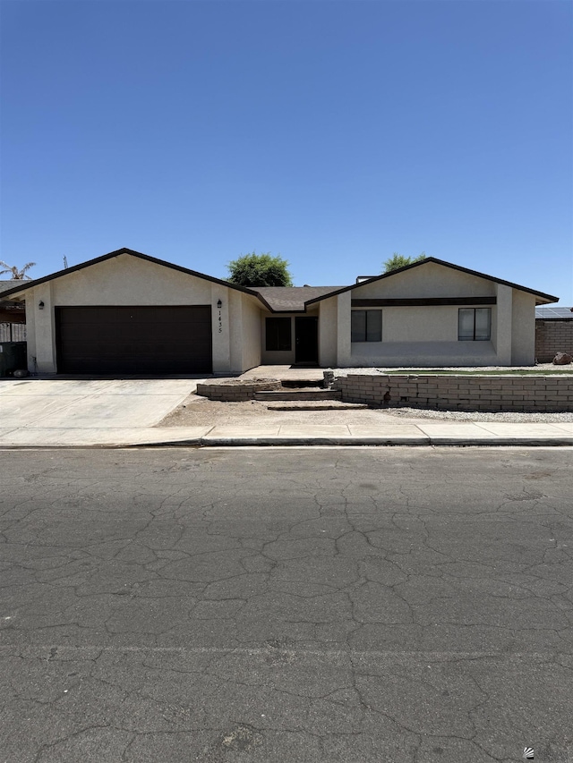 1435 S Thomas Ave, Yuma, AZ 85364 - ranch-style house with an attached garage, stucco siding, and concrete driveway