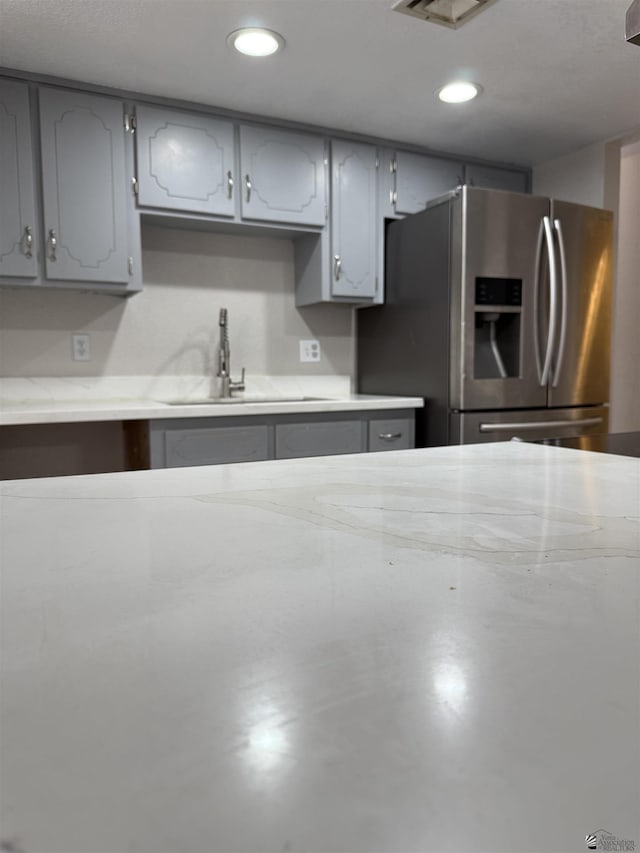 1435 S Thomas Ave, Yuma, AZ 85364 - kitchen with stainless steel fridge, gray cabinets, recessed lighting, and a sink