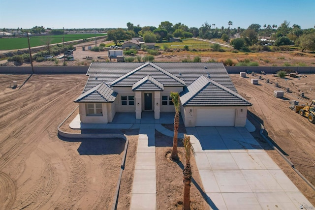 4766 W Clip St Unit 4766W, Rancho Escondido, Yuma, AZ 85364 - view of front of home featuring a garage, concrete driveway, a tile roof, and stucco siding