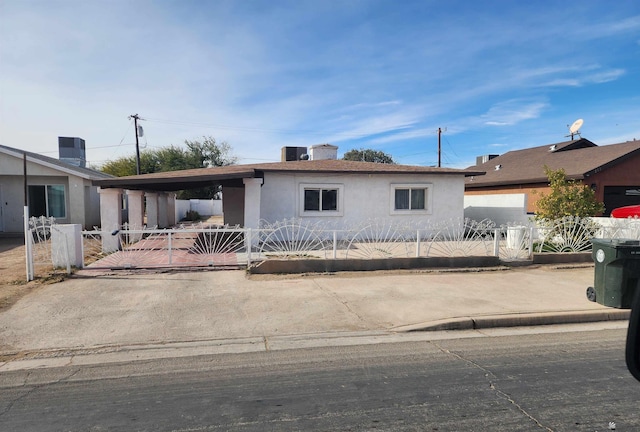 single story home with a gate, a fenced front yard, stucco siding, and central AC unit