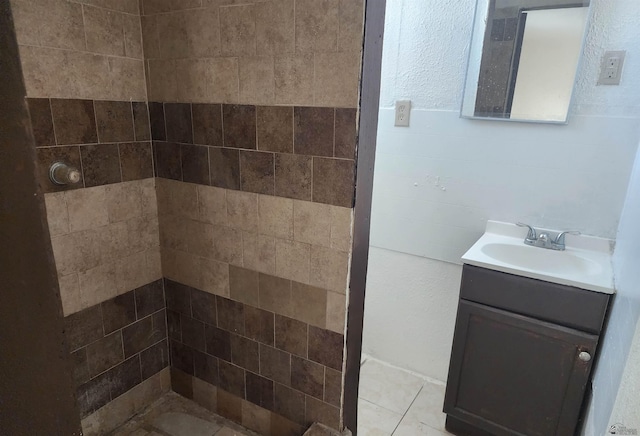 full bath with tiled shower and vanity