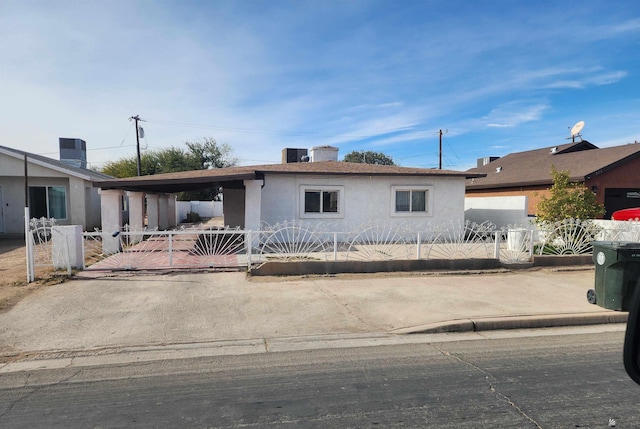 view of front of property featuring a fenced front yard, a gate, and stucco siding