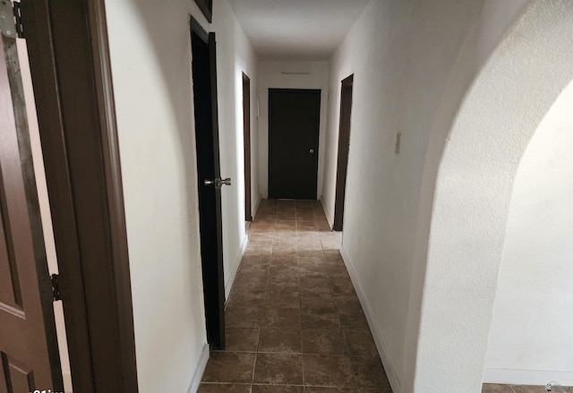 corridor featuring baseboards