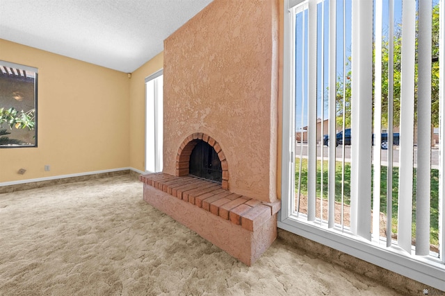 1228 S 40th Dr, Yuma, AZ 85364 - unfurnished living room with carpet, baseboards, lofted ceiling, and a fireplace