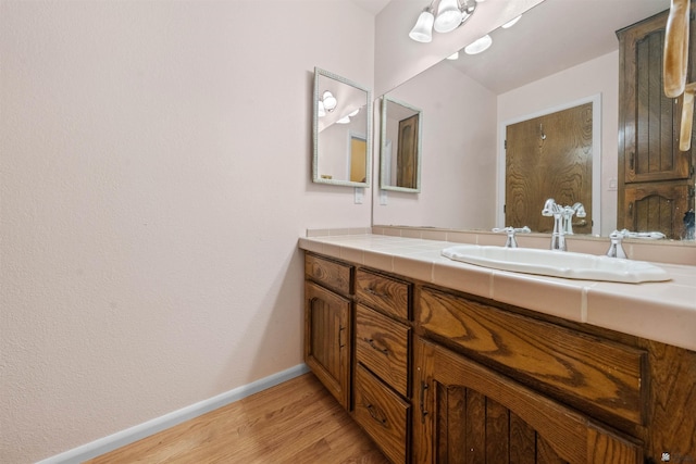 1228 S 40th Dr, Yuma, AZ 85364 - bathroom with vanity, wood finished floors, and baseboards