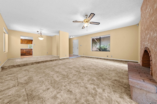 1228 S 40th Dr, Yuma, AZ 85364 - unfurnished living room with carpet flooring, a ceiling fan, a textured ceiling, and baseboards
