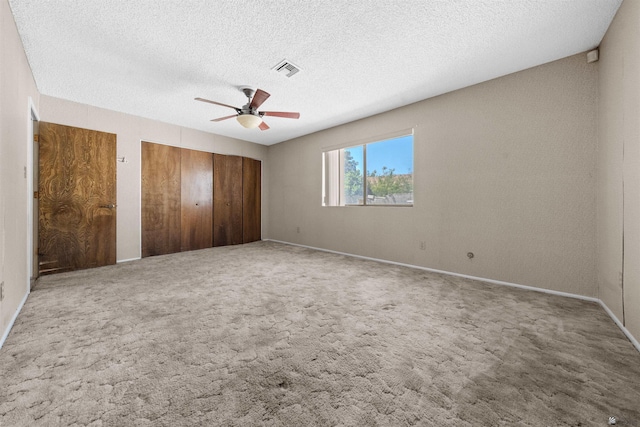 1228 S 40th Dr, Yuma, AZ 85364 - unfurnished bedroom with ceiling fan, baseboards, a textured ceiling, carpet floors, and a closet