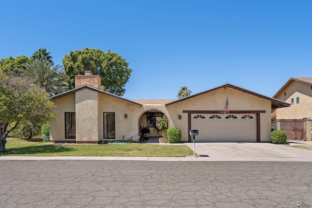 1228 S 40th Dr, Yuma, AZ 85364 - ranch-style home featuring a chimney, a garage, stucco siding, and driveway