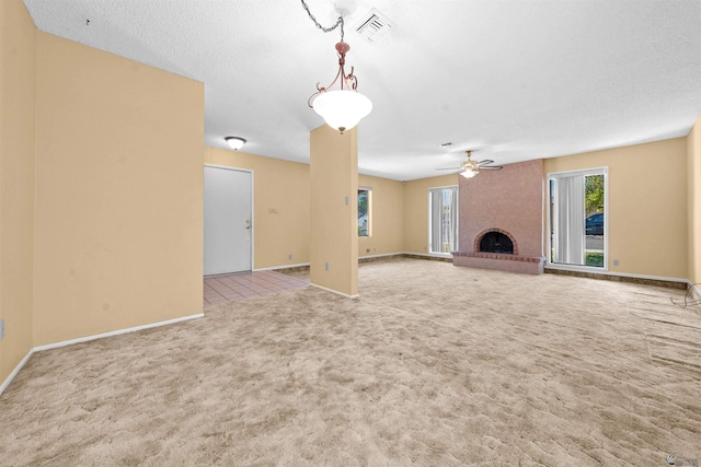 1228 S 40th Dr, Yuma, AZ 85364 - unfurnished living room featuring carpet floors, ceiling fan, a fireplace, and baseboards