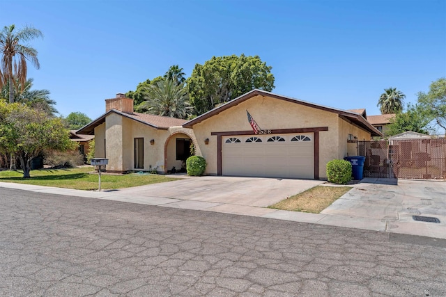 1228 S 40th Dr, Yuma, AZ 85364 - ranch-style home featuring stucco siding, a chimney, a gate, and a garage