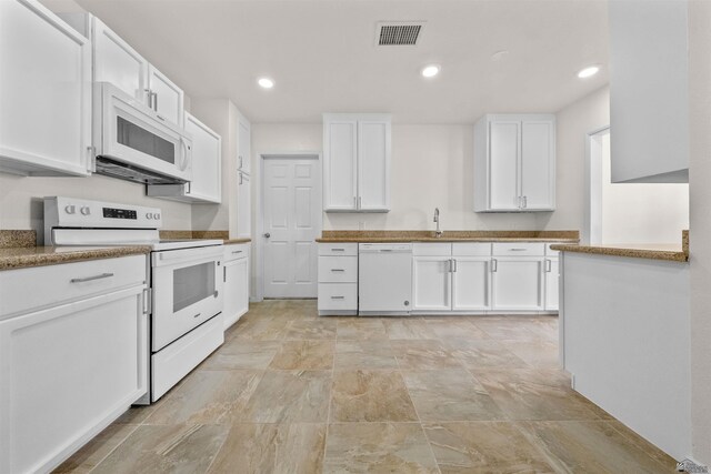 321 S 23rd Ave, Yuma, AZ 85364 - kitchen featuring visible vents, white appliances, stone finish floor, white cabinets, and a sink