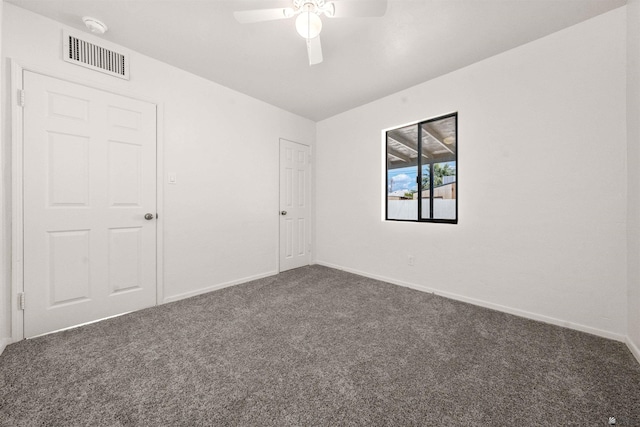 321 S 23rd Ave, Yuma, AZ 85364 - unfurnished bedroom with baseboards, visible vents, lofted ceiling, and dark colored carpet
