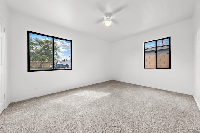 321 S 23rd Ave, Yuma, AZ 85364 - spare room featuring a healthy amount of sunlight, a ceiling fan, and carpet flooring