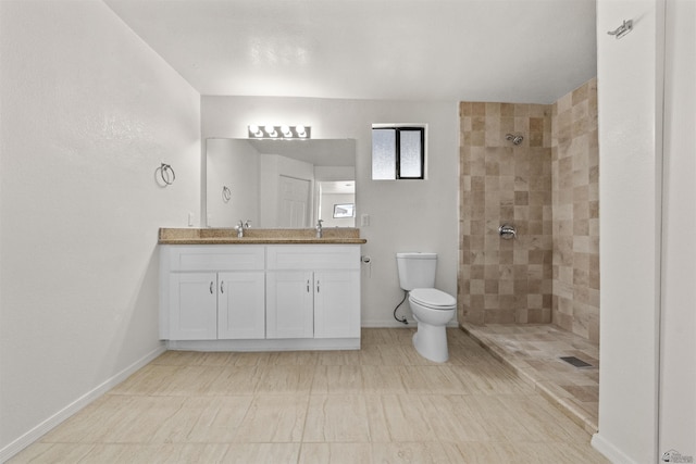 321 S 23rd Ave, Yuma, AZ 85364 - bathroom with a sink, double vanity, toilet, visible vents, and tiled shower