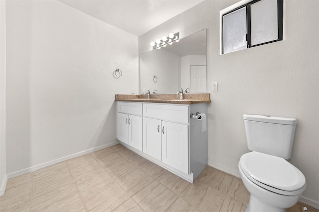 321 S 23rd Ave, Yuma, AZ 85364 - bathroom featuring baseboards, toilet, and vanity