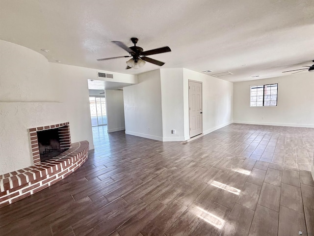 2472 S 18th Ave, Yuma, AZ 85364 - unfurnished living room with a ceiling fan, wood tiled floors, a fireplace, and a textured ceiling
