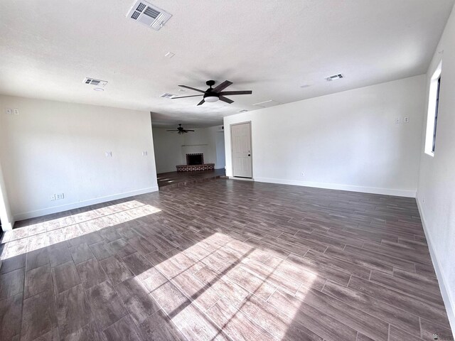 2472 S 18th Ave, Yuma, AZ 85364 - unfurnished living room featuring wood tiled floors, ceiling fan, and a fireplace