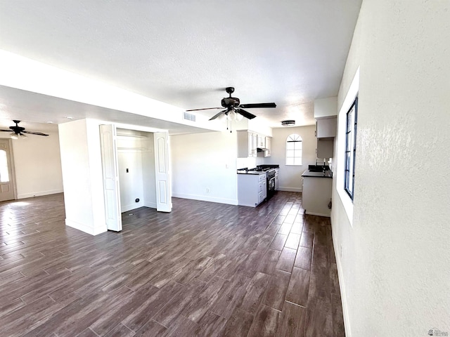 2472 S 18th Ave, Yuma, AZ 85364 - unfurnished living room featuring a ceiling fan and dark wood finished floors
