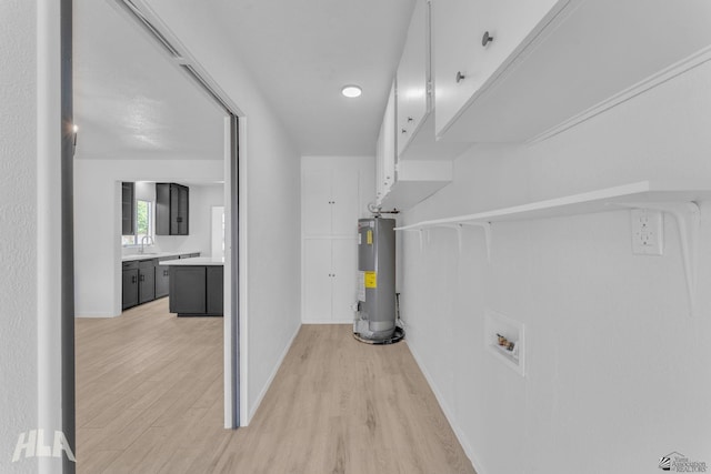 utilities with water heater and a sink