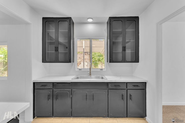 bar with baseboards and a sink