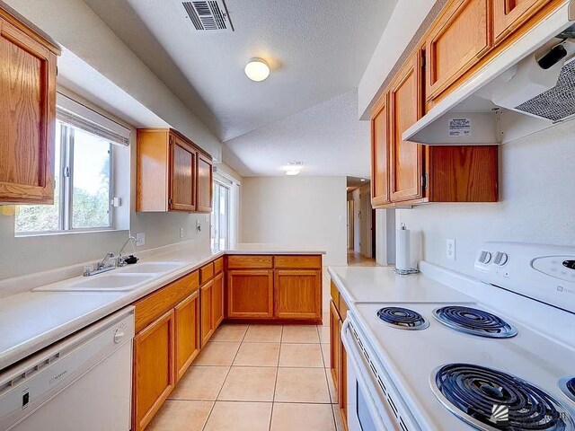8576 E 38th St, Yuma, AZ 85365 - kitchen with white appliances, under cabinet range hood, light countertops, light tile patterned floors, and a textured ceiling