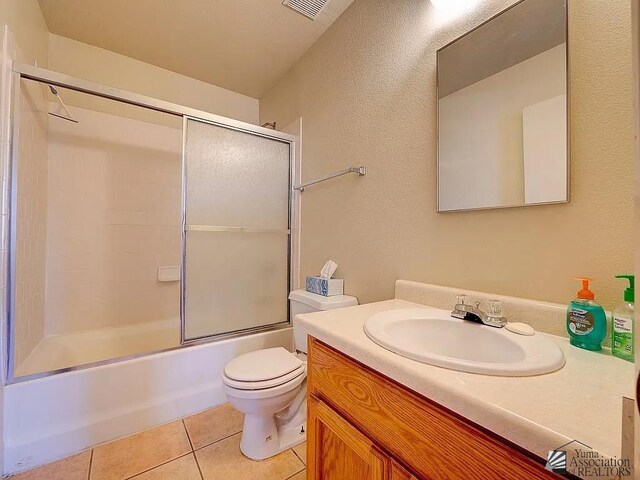 8576 E 38th St, Yuma, AZ 85365 - full bath featuring vanity, tile patterned floors, shower / bath combination with glass door, and a textured wall