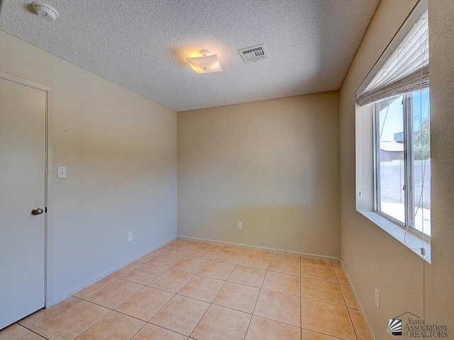 8576 E 38th St, Yuma, AZ 85365 - empty room with light tile patterned flooring, a textured ceiling, and a smoke detector