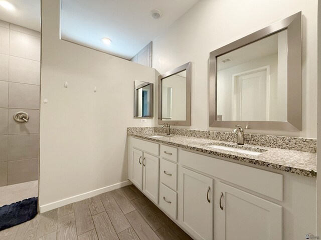 14650 E 42nd Pl, Yuma, AZ 85367 - bathroom with wood finished floors, double vanity, and baseboards