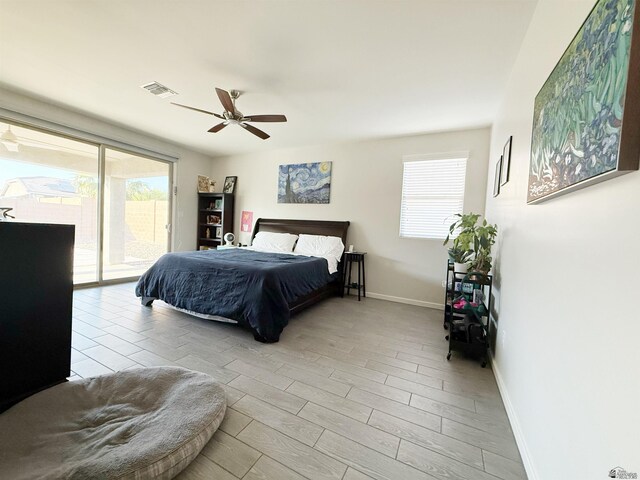 14650 E 42nd Pl, Yuma, AZ 85367 - bedroom featuring access to outside, multiple windows, baseboards, and wood finished floors