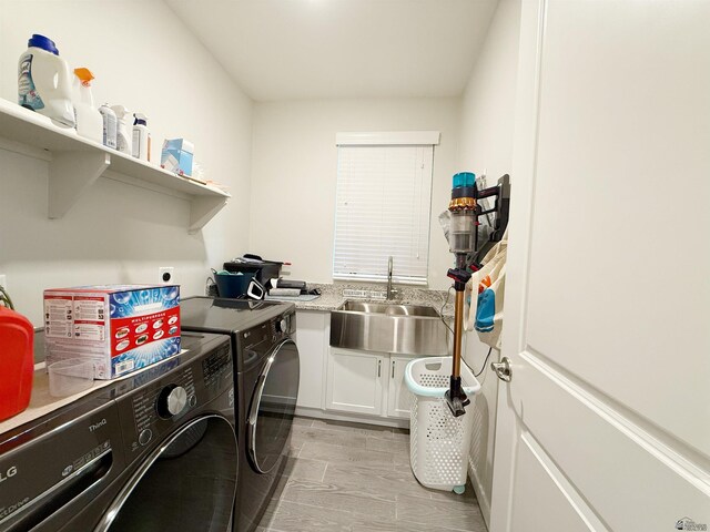 14650 E 42nd Pl, Yuma, AZ 85367 - washroom featuring washer and dryer, cabinet space, and light wood finished floors