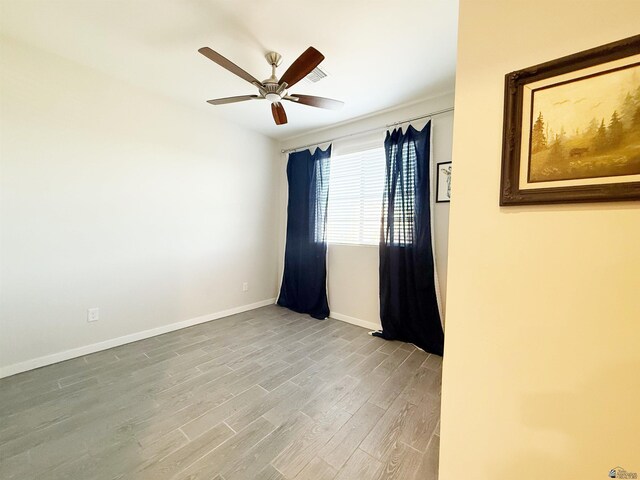 14650 E 42nd Pl, Yuma, AZ 85367 - empty room featuring wood finished floors, a ceiling fan, and baseboards