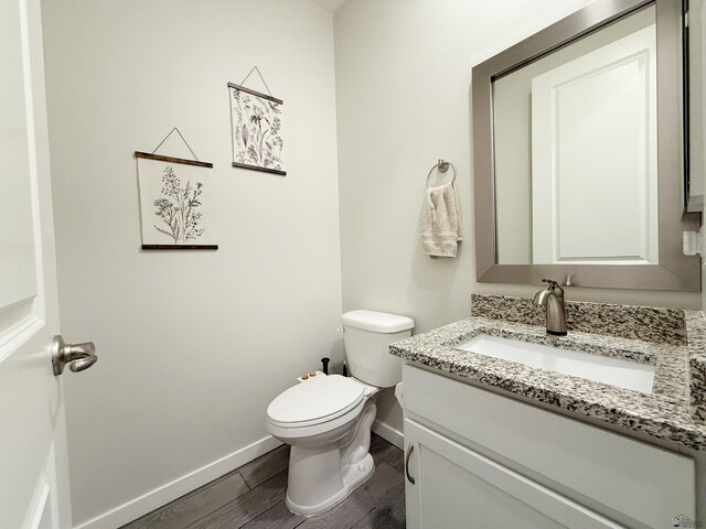 14650 E 42nd Pl, Yuma, AZ 85367 - bathroom with vanity, baseboards, toilet, and wood finished floors