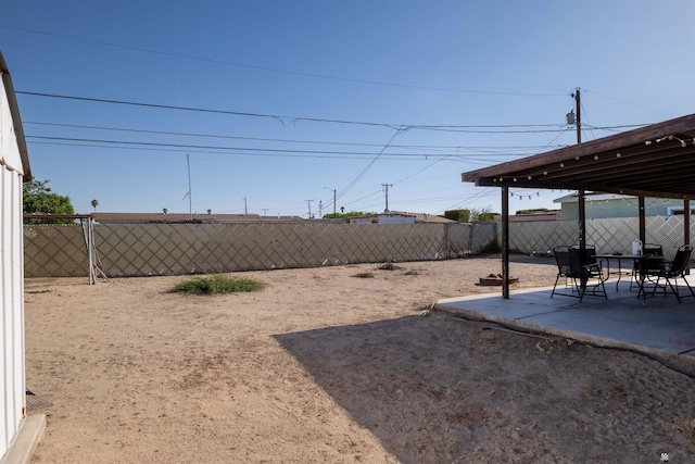 fenced backyard with a patio area