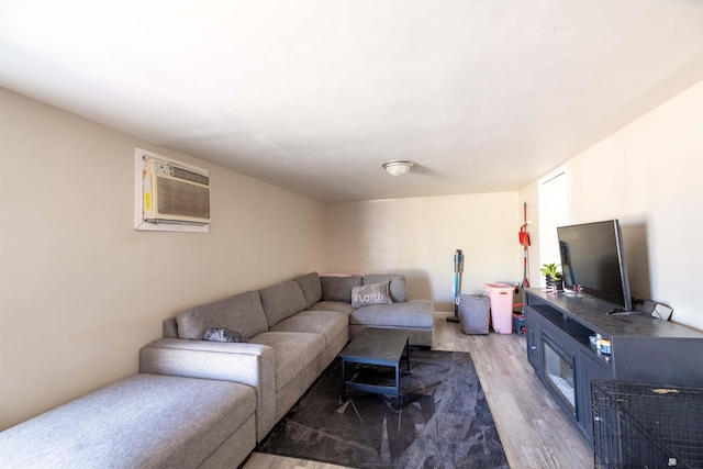 living area with light wood-style flooring and a wall mounted AC