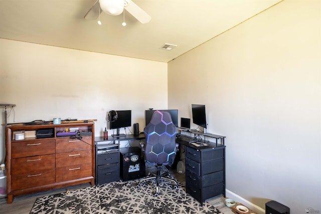 office area with a ceiling fan, wood finished floors, and baseboards
