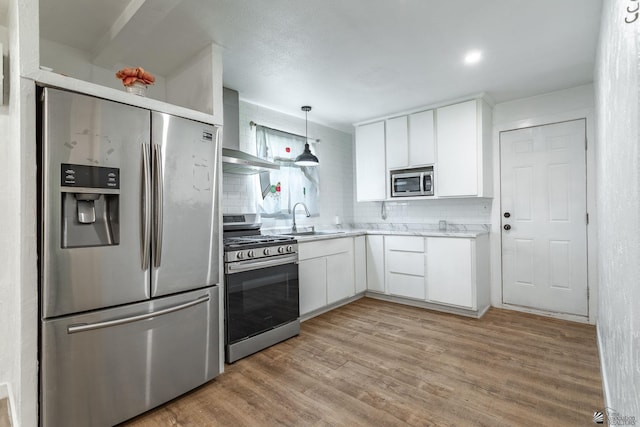 3566 W 5th St, Yuma, AZ 85364 - kitchen featuring stainless steel appliances, wall chimney range hood, white cabinets, and light countertops