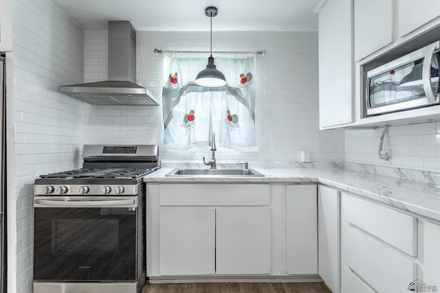 3566 W 5th St, Yuma, AZ 85364 - kitchen with appliances with stainless steel finishes, wall chimney exhaust hood, a sink, and tasteful backsplash
