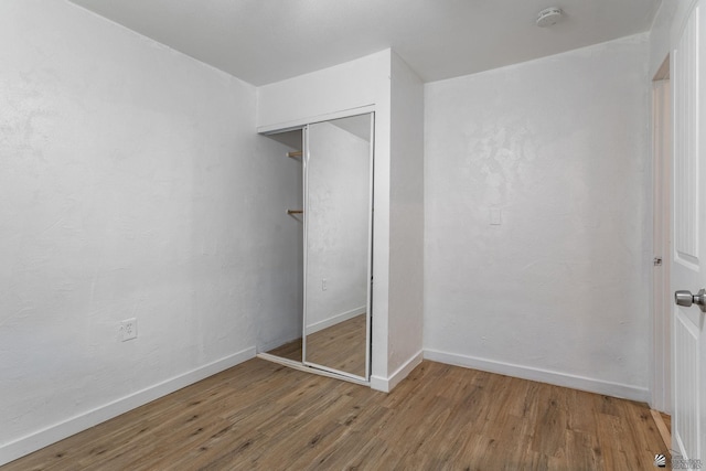 3566 W 5th St, Yuma, AZ 85364 - unfurnished bedroom featuring wood finished floors, baseboards, and a closet