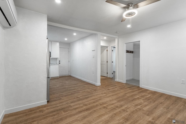 3566 W 5th St, Yuma, AZ 85364 - spare room featuring baseboards, a wall unit AC, recessed lighting, and light wood finished floors