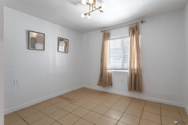 3566 W 5th St, Yuma, AZ 85364 - empty room with a chandelier, baseboards, and light tile patterned floors