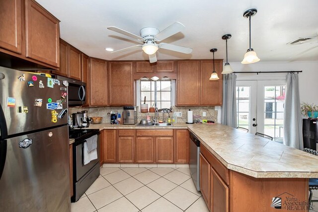 4539 W 17th St, Yuma, AZ 85364 - kitchen featuring appliances with stainless steel finishes, a sink, a peninsula, light countertops, and brown cabinetry