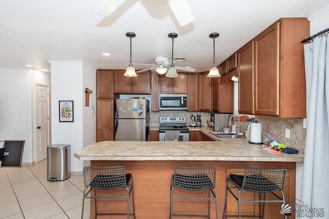 4539 W 17th St, Yuma, AZ 85364 - kitchen with appliances with stainless steel finishes, a ceiling fan, a sink, brown cabinetry, and recessed lighting