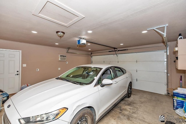 4539 W 17th St, Yuma, AZ 85364 - garage featuring a garage door opener, recessed lighting, and an AC wall unit