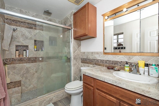 4539 W 17th St, Yuma, AZ 85364 - bathroom featuring vanity, a shower stall, tile walls, and toilet