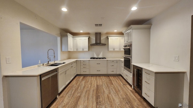 1350 S 6th Ave, Yuma, AZ 85364 - kitchen with appliances with stainless steel finishes, wall chimney range hood, light wood finished floors, beverage cooler, and recessed lighting