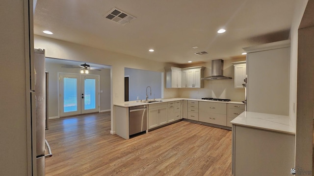 1350 S 6th Ave, Yuma, AZ 85364 - kitchen featuring wall chimney range hood, dishwasher, light wood-style flooring, gas cooktop, and recessed lighting