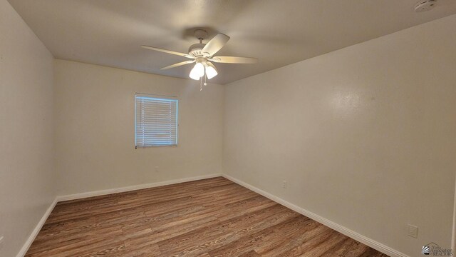 1350 S 6th Ave, Yuma, AZ 85364 - unfurnished room featuring a smoke detector, wood finished floors, and ceiling fan