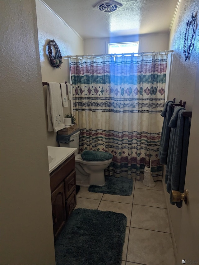 bathroom featuring vanity, curtained shower, tile patterned floors, and toilet