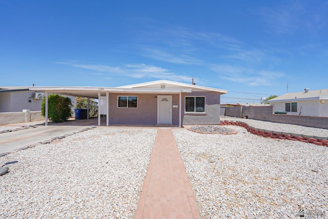 1148 W 33rd St, Yuma, AZ 85365 - view of front facade featuring fence, a carport, driveway, and stucco siding